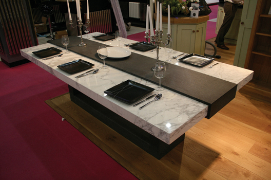 Arabescato marble table top with brushed granite legs and center piece